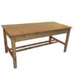 A rectangular pine plank top kitchen table, raised on four legs united by stretchers,