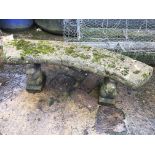 A reconstituted stone bench, of crescent form,