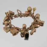 A 9 carat gold bracelet, of solid fetter and three style links, with eighteen charms attached,