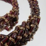 A plaited garnet bead necklace, graduated, with a matching bracelet,