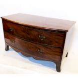 A low mahogany chest, of bow front form, fitted with two long drawers,