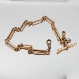 A 15 carat gold watch chain, of fetter and three links, with a T bar and swivels, 38cm long,