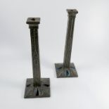 A pair of Arts and Crafts pewter mounted candlesticks,
