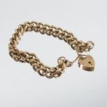 A 9 carat gold bracelet, of solid curb links to a padlock clasp,