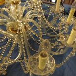 A glass chandelier, with ten branches, having glass bead swag,