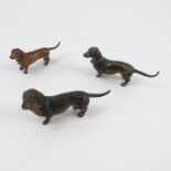 Three cold painted bronze models, of dachshunds, height 1.