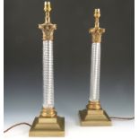 A pair of Vaughan brass and glass Corinthian column table lamps,