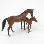 A cold painted bronze model, of a bay mare and foal, af,