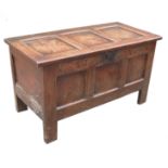 An 18th century oak coffer, with three panels to the front and plain rising lid,