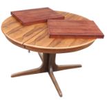 A 1970s circular rosewood extending dining table, raised on L shaped legs, width 47ins,