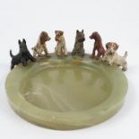 Six cold painted bronze models, of different working dogs, all mounted on a green onyx base,