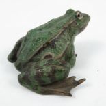 A cold painted bronze model, of a green toad, with glass eyes (one missing), stamped 1408,