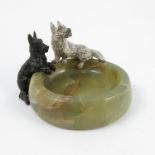 Two cold painted bronze models, of black and white Scottish Terriers, mounted on a green onyx base,