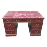 A mahogany desk, fitted with three drawers to each side and raised on a pedestal,