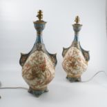 A pair of Royal Worcester table lamps, with blue ground necks and pierced handles,