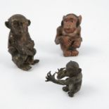 Three cold painted bronze models, of seated monkeys, height 2.
