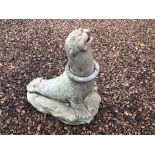 A garden statue, of a seal with a rubber ring around its neck,