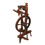 An Antique beech upright flyer spinning wheel, with ring turned supports,