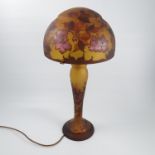 A glass table lamp, the glass dome shade and baluster shaped base marked Galle,