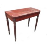 A 19th century mahogany fold over games table, raised on four reeded legs with bell push moulding,