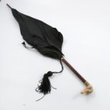 A Paragon S Fox & Co Limited black umbrella, the handle terminating in a carved ivory ducks head,