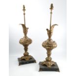 A pair of brass table lamps, formed as Classical ewers, on a rectangular marble base with gilt feet,