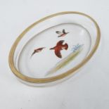 An oval glass dish, painted with three partridge i