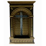 A painted wooden alcove, in black and gold, with Latin script, gilt rosettes, shields and other