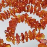 An amber necklace, of small tumbled beads, 150cm long, 41.5g gross