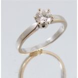 A diamond single stone ring, the white mount stamped '750', the brilliant cut of approximately 0.