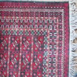 An Eastern style prayer rug, decorated in red, whi