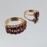 A seven stone garnet 18 carat gold ring, together with a single stone garnet ring stamped '18ct',