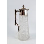 A glass and silver mounted claret jug, the tapered cylindrical cut glass body with silver mount