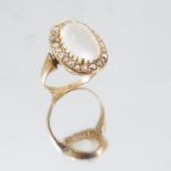 A moonstone and diamond cluster ring, the oval cab