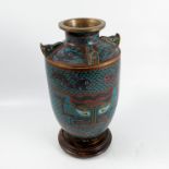 A cloisonné vase, the top having four lugs decorated with stylised masks, the blue ground body