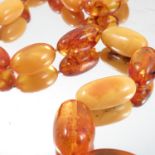 An amber necklace, of graduated oval beads, 80cm long, 117g gross