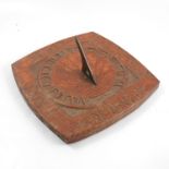 An Arts and Crafts carved oak wall sundial, with copper gnomon, 12ins square