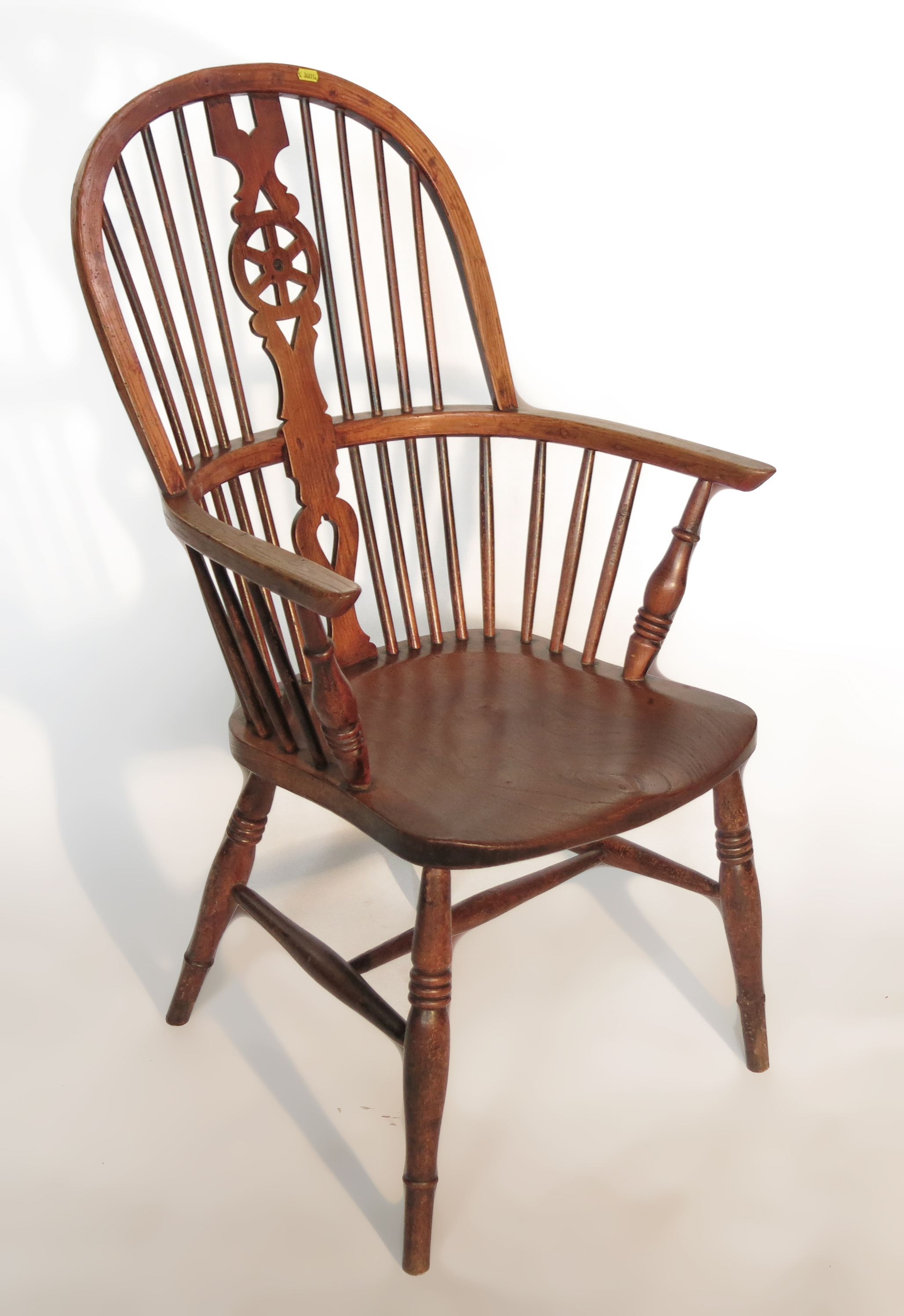 A 19th century wheel back Windsor arm chair, raise