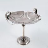 A silver pedestal dish, the shaped circular top having a pair of handles, raised on a knopped
