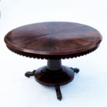 A 19th century mahogany circular breakfast table, raised on a turned column, platform base with