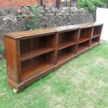 A large oak book case, in two sections, with carved decoration and adjustable shelves, on plinth