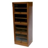 An oak display cabinet, having four glazed doors and two sliding drawers, bearing label Courtney