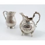 A continental silver jug, of baluster form with embossed decoration and raised on three scroll legs,