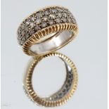 A two colour 18 carat gold diamond ring, the frontispiece pave set with forty three diamonds,