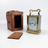 A brass cased repeating carriage clock, with white enamel dial and Roman numerals, height