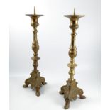 A pair of brass pricket candles stands, raised on turned column, to a triform base, height 26ins