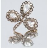 A rose diamond clover leaf brooch, circa 1900, the principal stones enclosed by graduated rose cuts,