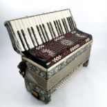 A Frontalini Italia piano accordion, with grey marbled case and black and white pierced panel