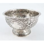 A silver pedestal bowl, of circular form, with embossed scroll and floral decoration, London 1901,