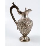 A silver hot water jug, of baluster form, the body embossed with scroll and flower decoration,